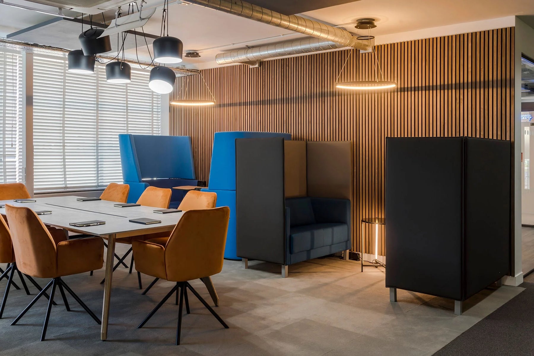 Wood wall paneling installation in a modern office space.